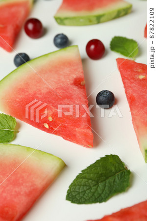 Flat lay with watermelon slices and berries on white background 87822109