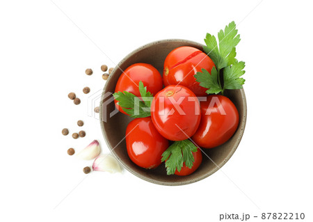 Bowl with pickled tomatoes and spices isolated on white background Bowl with pickled tomatoes and spices isolated on white background 87822210