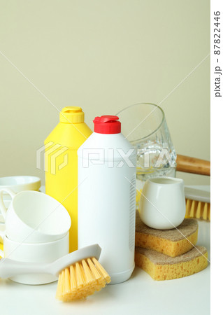 Concept of different Dishwashing detergent accessories on white table Concept of different Dishwashing detergent accessories on white table 87822446