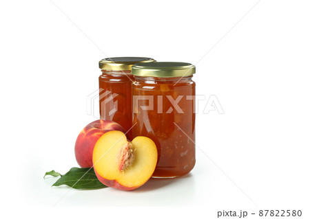Jars of peach jam and ingredient isolated on white background 87822580