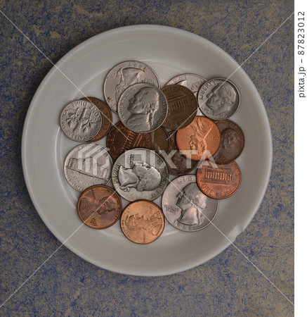 small american coins on a white saucer small american coins on a white saucer 87823012