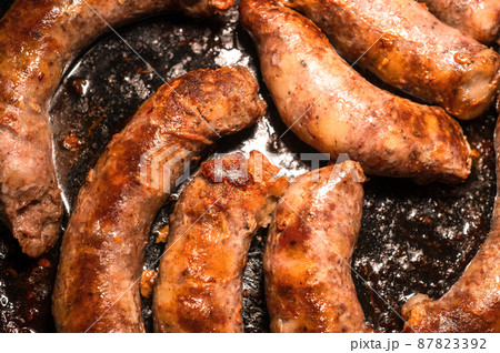 Fried homemade sausages in a frying pan Fried homemade sausages in a frying pan 87823392