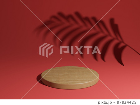 Bright maroon, dark red simple 3D render minimal natural product display composition with one wood podium or stand with palm leaf shadow in the background 87824425