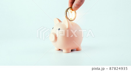 Save currency bitcoin. Pink pig bank with golden bit coin money BTC on white background. Save money investment and business finance. 87824935