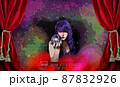 Psychic with Crystal Ball and tarot cards in Red Velvet Tent 87832926