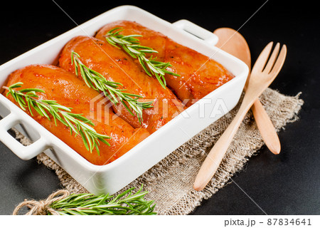 Fresh chicken.Convenience food,precooked.Raw marinated chicken.Marinated chicken fillet with spices.Cooking chicken with spices in the oven. 87834641