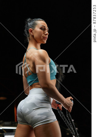 Muscular Woman in Gym Showing Back Muscles. Strong Fitness Girl