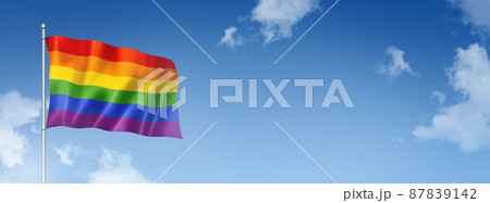 Rainbow gay pride flag isolated on a blue sky. Horizontal banner 87839142