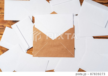 Stack of envelopes on working desk top view. Business mail Stack of envelopes on working desk top view. Business mail 87839273