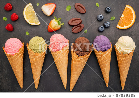 Flat lay ice cream cones collection on dark stone background . Blank crispy ice cream cone with copy space for sweets menu design. 87839388