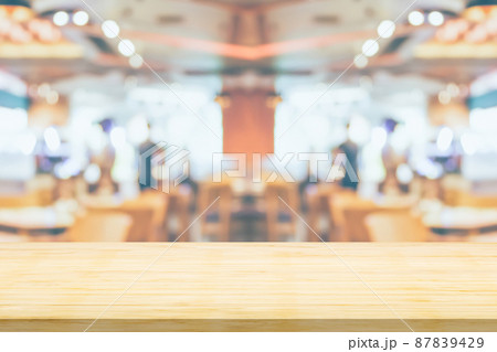 Empty wood table top with cafe restaurant interior blurred background Empty wood table top with cafe restaurant interior blurred background 87839429