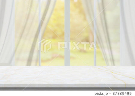 Marble table top on blur room interior with window curtain background 87839499