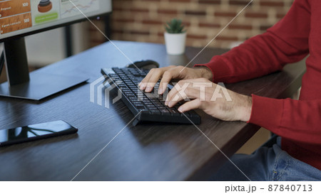Businessman planning marketing analysis with sales data on monitor, using e commerce statistics charts and graphs. Employee working with online information on computer. Handheld shot. Close up. Businessman planning marketing analysis with sales data on monitor, using e commerce statistics charts and graphs. Employee working with online information on computer. Handheld shot. Close up. 87840713
