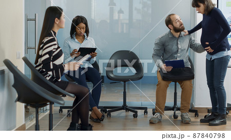 Male candidate attending job interview with pregnant employee, preparing for professional recruitment meeting in office. Woman inviting man to start job application appointment. Male candidate attending job interview with pregnant employee, preparing for professional recruitment meeting in office. Woman inviting man to start job application appointment. 87840798