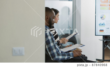 HR worker inviting female applicant to attend job interview in office, leaving waiting lobby. Woman starting selection meeting appointment with executive manager, talking about employment. HR worker inviting female applicant to attend job interview in office, leaving waiting lobby. Woman starting selection meeting appointment with executive manager, talking about employment. 87840968