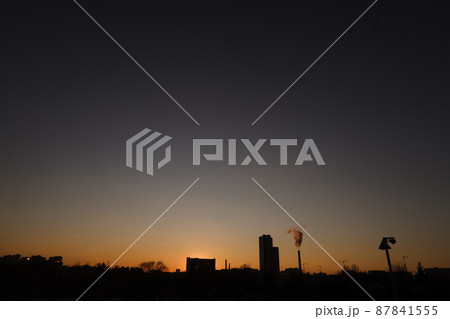 Dramatic landscape of a city skyline at sunset. Large city architecture. Dramatic landscape of a city skyline at sunset. Large city architecture. 87841555