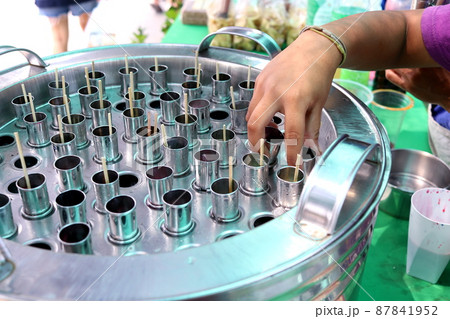 Bamboo stick in tube and hand is keeping it. 87841952