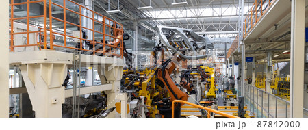 Panoramic photo of automobile production line. Welding car body. Modern car assembly plant. Auto Panoramic photo of automobile production line. Welding car body. Modern car assembly plant. Auto 87842000