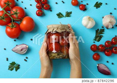 Concept of pickled vegetables with tomatoes on blue background Concept of pickled vegetables with tomatoes on blue background 87842296