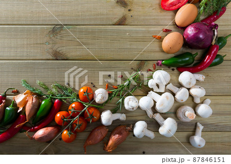 Mushrooms, vegetables, herbs on wooden surface 87846151