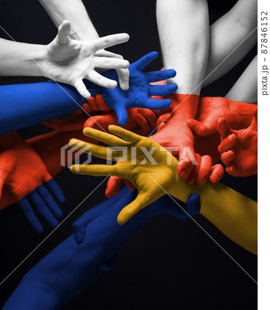 Painted hands of people's crows in touch isolated on dark studio background. Concept of human relation, community, togetherness, symbolism. 87846152