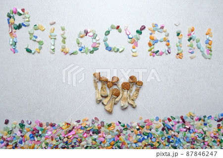"Psilocybin" inscription. Psychedelic mushrooms on textured background. "Psilocybin" inscription. Psychedelic mushrooms on textured background. 87846247