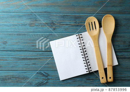 Empty recipe book and utensils on wooden table Empty recipe book and utensils on wooden table 87853996
