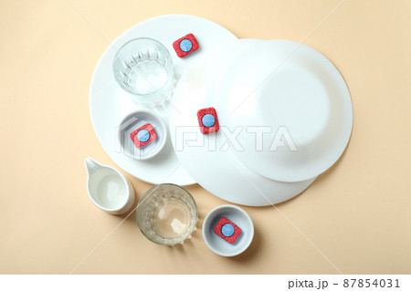 Concept of Dishwashing detergent accessories on beige background 87854031