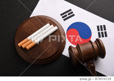 Cigarettes, wooden Judge gavel and South Korea flag. Justice and Tobacco law. Tobacco control act. Top view. 87854239
