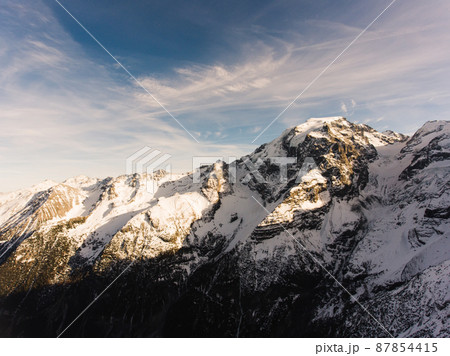 Mountain terrain with snowy peaks Mountain terrain with snowy peaks 87854415