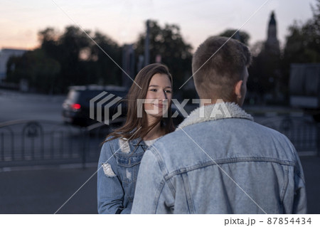 Young guy and girl on the street. Stroll. Date. 87854434