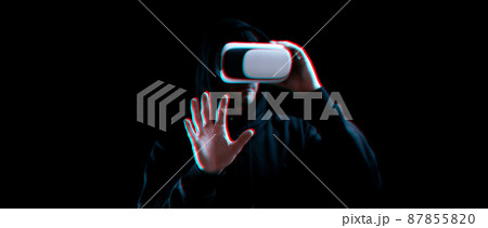 Vr goggles virtual reality blured. Young man in digital helmet for 3d virtual reality game on dark background. Study and virtual world in 3D simulation with glitch effect. Vr goggles virtual reality blured. Young man in digital helmet for 3d virtual reality game on dark background. Study and virtual world in 3D simulation with glitch effect. 87855820