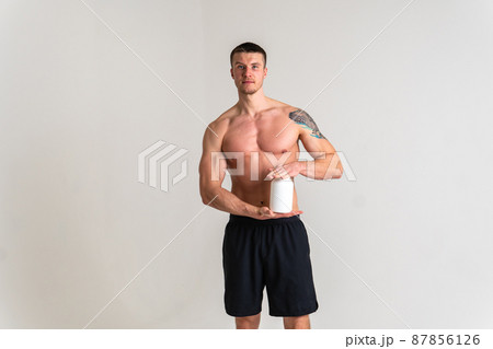 Fitness protein jars white on white background bodybuilder powder strong high ache body cramp spine young medical, holding. Tension therapy, ain suffer attractive 87856126