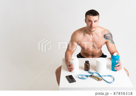 Fitness protein jars white on white background bodybuilder powder strong high back cramp male health hand Hold lumbar problem suffer attractive Fitness protein jars white on white background bodybuilder powder strong high back cramp male health hand Hold lumbar problem suffer attractive 87856318