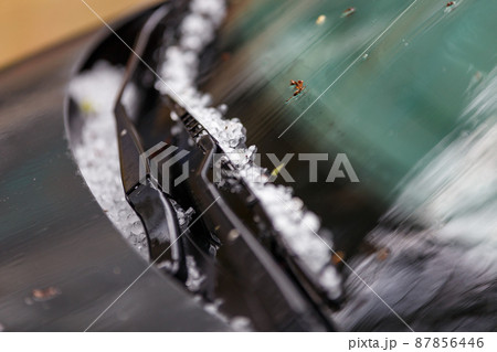 small hail ice balls on black car hood after heavy summer storm 87856446