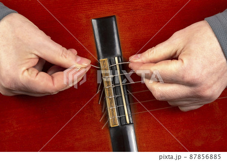 replacement and insertion of nylon strings in a classical guitar. lesson for a musician replacement and insertion of nylon strings in a classical guitar. lesson for a musician 87856885