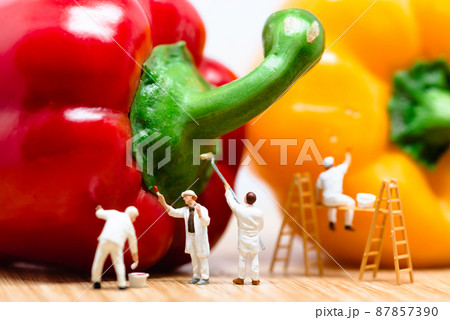Miniature painters coloring bell pepper. Macro photo 87857390