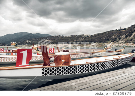 Empty dragon boats ready for race. Tinted photo. Empty dragon boats ready for race. Tinted photo. 87859379