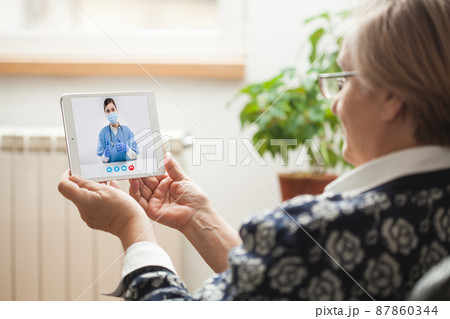 Elderly caucasian woman talking to young female e-doctor via online video chat Elderly caucasian woman talking to young female e-doctor via online video chat 87860344