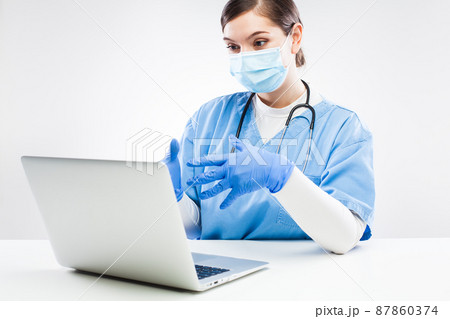 UK NHS GP doctor chatting to patient over computer UK NHS GP doctor chatting to patient over computer 87860374