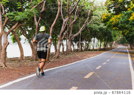 Back view of Asian sportsman exercise jogging in the park. Back view of Asian sportsman exercise jogging in the park. 87864116