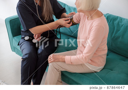 Old lady with medical practitioner on appointment 87864647