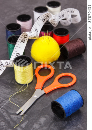 Spools of thread, needle, tape measure and scissors. Accessories for needlework 87870431