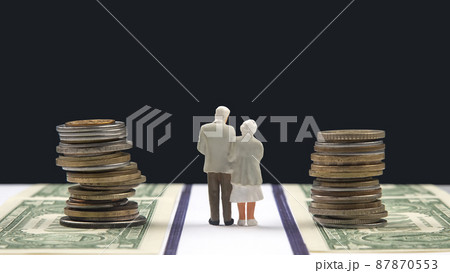 Miniature people. Elderly people, retirees, walk the road of life along the money towards the end  87870553