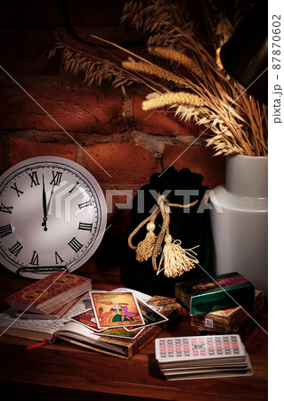 Blurred predictions background. Tarot cards layout on witch table. Blurred predictions background. Tarot cards layout on witch table. 87870602