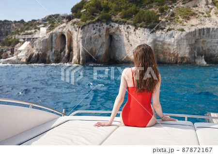 Woman resting on a yacht in the sea in Zakynthos Woman resting on a yacht in the sea in Zakynthos 87872167