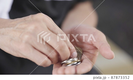 小銭を数える男性　手元 87873352