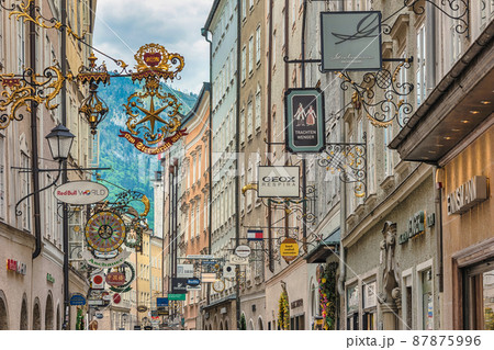 Salzburg, Austria city skyline and wrought iron signs at Grain Lane street the famous shopping street of Salzburg Austria Salzburg, Austria city skyline and wrought iron signs at Grain Lane street the famous shopping street of Salzburg Austria 87875996