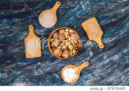 Alternative nut flour. Vegan baking. Almond, walnut, cashew flour. Flat lay black background 87876485