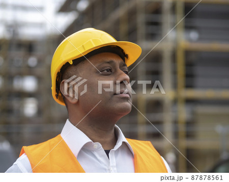 Profile portrait of a serious civil engineer or factory worker wearing a safety helmet and looking aside 87878561